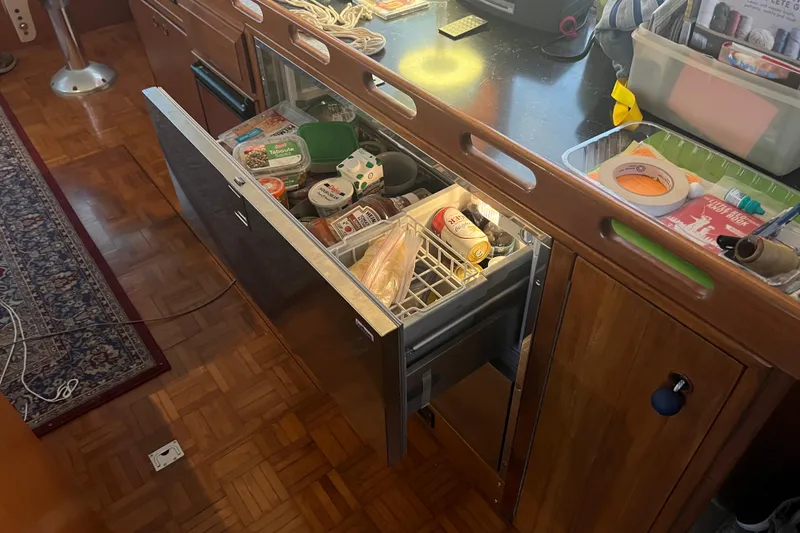 Slide: The Image of Kitchen area of a 1998 DeFever 44 Sundeck Trawler with open refrigerator drawer. - 13