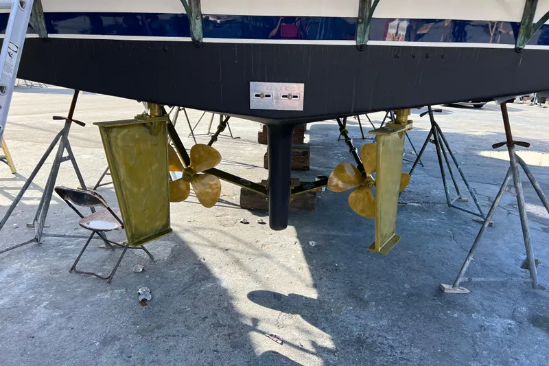 Slide: The Image of 1998 DeFever 44 Sundeck Trawler's propellers and rudders on dry dock. - 16