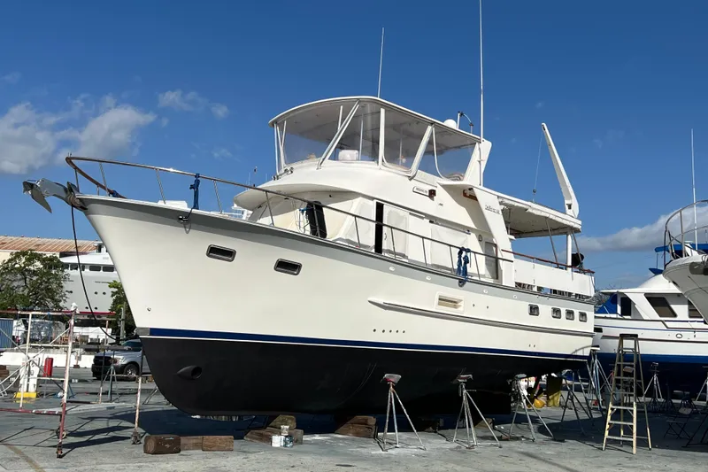 Slide: The Image of 1998 DeFever 44 Sundeck Trawler on dry dock under clear blue sky. - 18