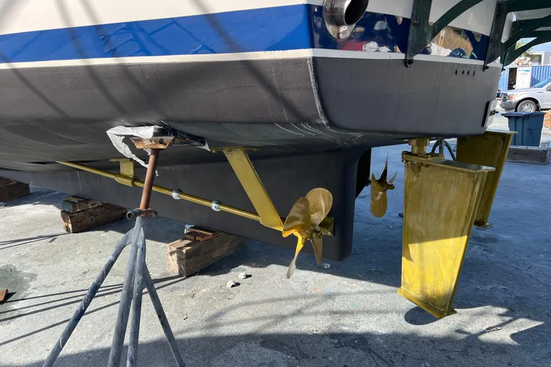 Slide: The Image of 1998 DeFever 44 Sundeck Trawler on stands, showcasing propellers and rudders. - 23