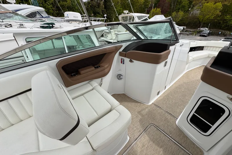 Slide: The Image of Luxurious interior of a 2018 Cobalt R35 boat with white seating and brown accents. - 16