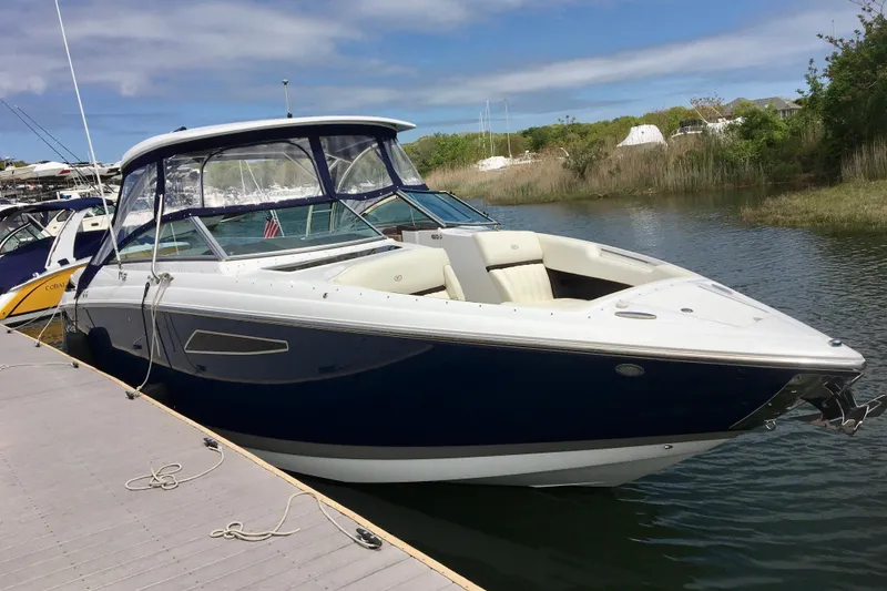 Slide: The Image of 2018 Cobalt R35 boat docked on a sunny day, featuring sleek design and spacious seating. - 2