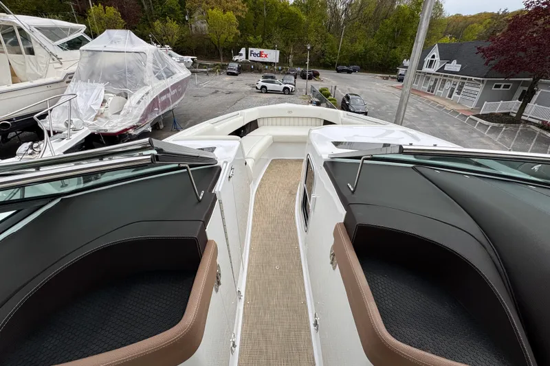 Slide: The Image of Bow view of 2018 Cobalt R35 boat in a marina with surrounding greenery. - 20
