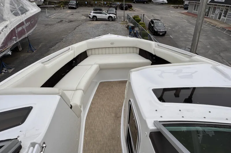 Slide: The Image of 2018 Cobalt R35 boat with spacious white seating area, parked in a marina. - 21