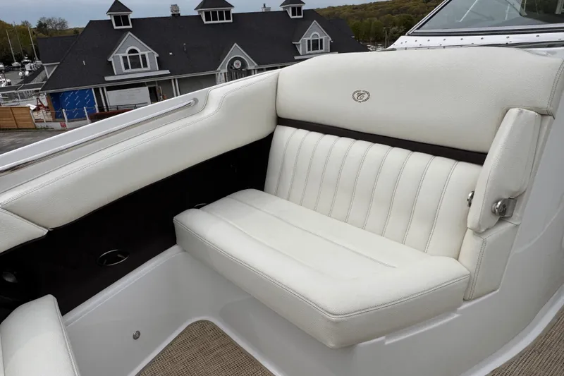 Slide: The Image of Luxurious white seating on a 2018 Cobalt R35 boat, with elegant stitching and marina backdrop. - 24