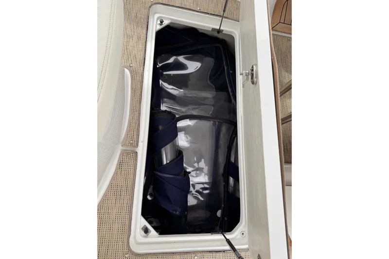 Slide: The Image of Storage compartment in a 2018 Cobalt R35 boat, featuring neatly organized equipment. - 28
