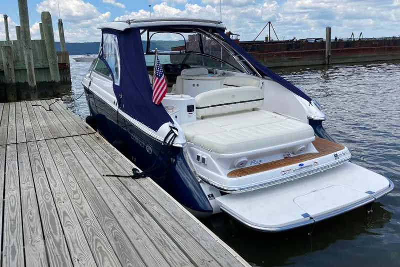 Slide: The Image of 2018 Cobalt R35 boat docked at a marina, featuring a sleek design and American flag. - 3