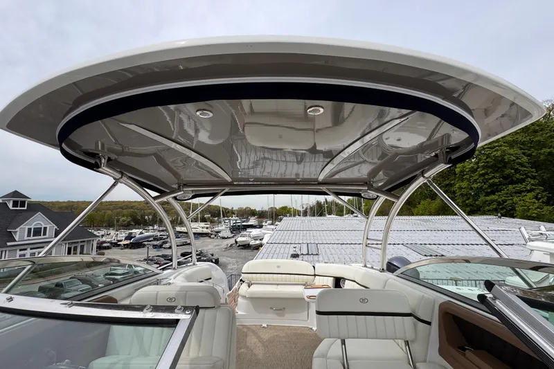 Slide: The Image of 2018 Cobalt R35 boat interior with sleek design and spacious seating under a canopy. - 30