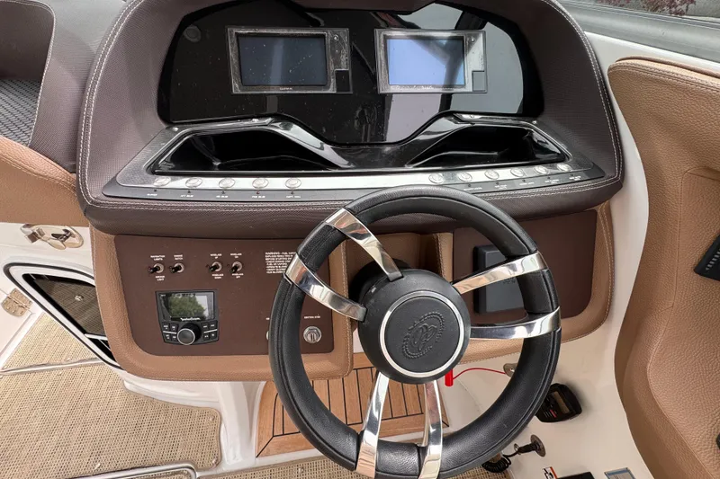 Slide: The Image of Steering wheel and dashboard of a 2018 Cobalt R35 boat with dual screens. - 34