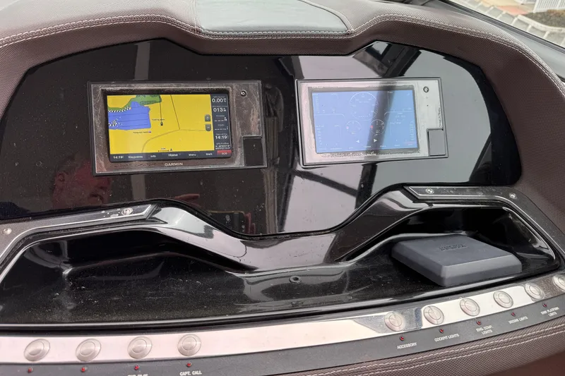 Slide: The Image of Dashboard of a 2018 Cobalt R35 boat with dual Garmin navigation screens. - 35