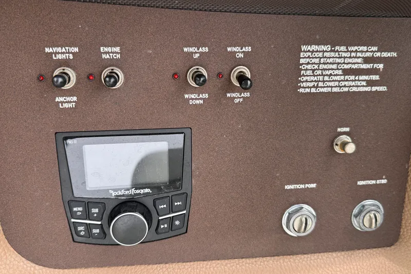 Slide: The Image of Control panel of a 2018 Cobalt R35 boat with switches and audio system. - 36
