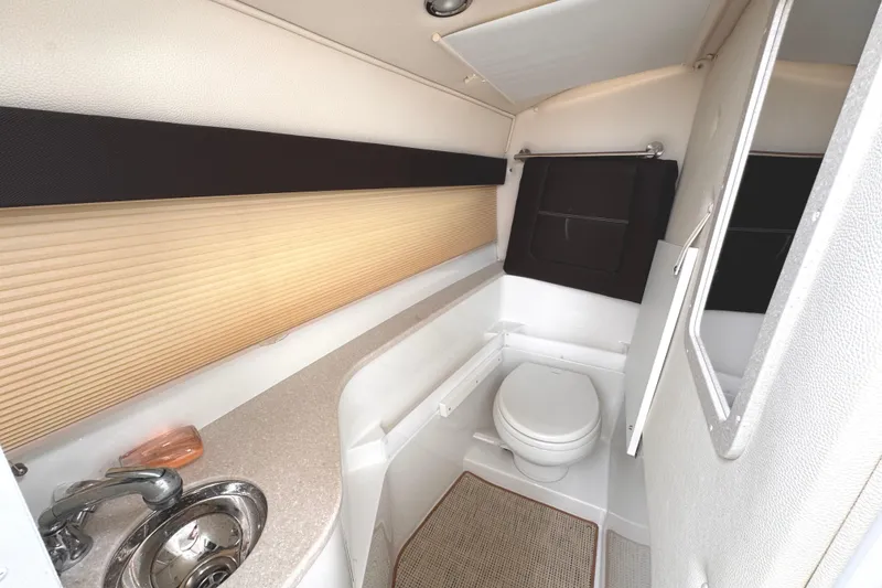 Slide: The Image of 2018 Cobalt R35 boat interior bathroom with sink, toilet, and mirror. - 46
