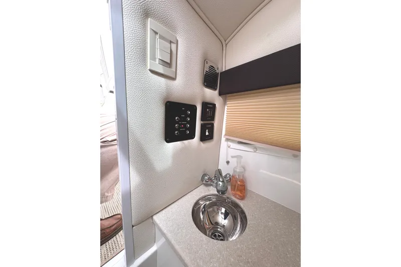 Slide: The Image of Compact sink area in 2018 Cobalt R35 boat with control panel and soap dispenser. - 47