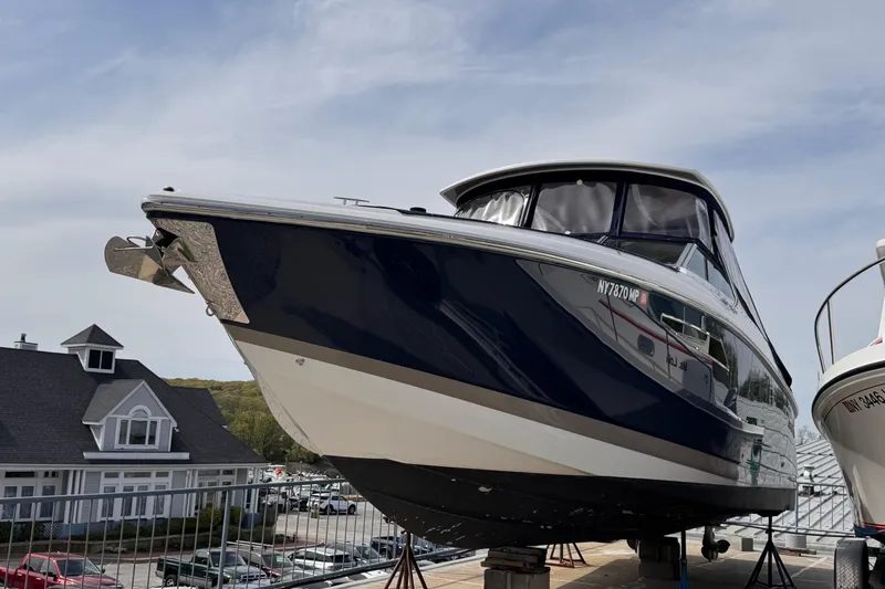 Slide: The Image of 2018 Cobalt R35 boat on display at a marina, clear sky background. - 52