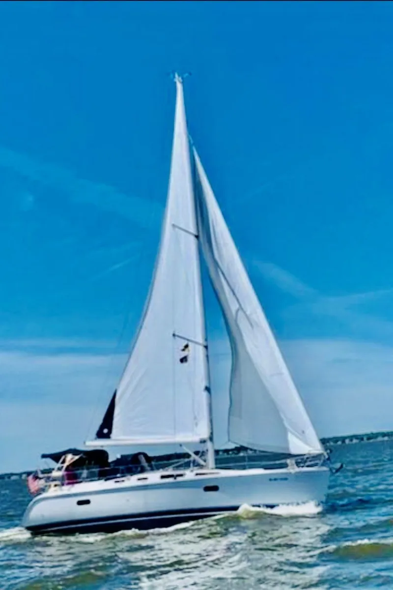 The Image of 2002 Hunter 356 sailboat cruising on open water. - 0
