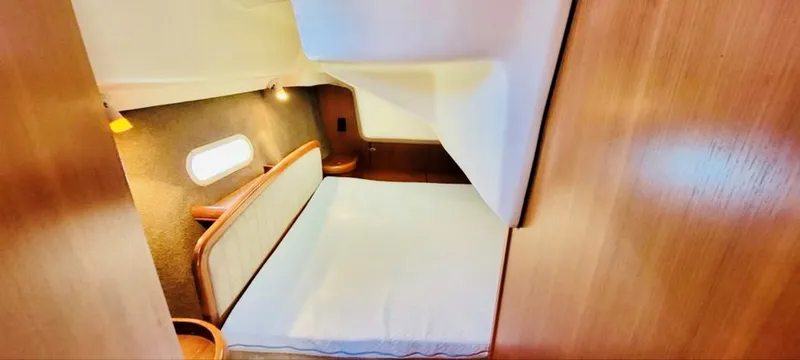 Slide: The Image of Interior of a 2002 Hunter 356 yacht featuring a cozy sleeping cabin. - 11