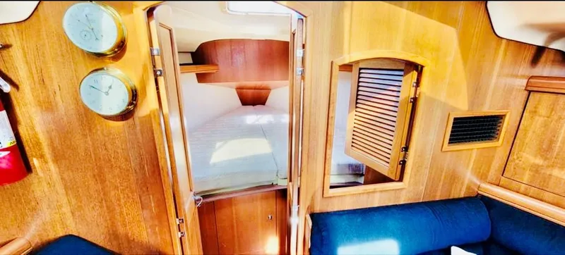 Slide: The Image of Interior of a 2002 Hunter 356 yacht with wooden finish. - 12