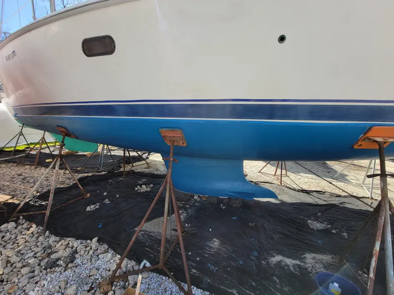 Slide: The Image of 2002 Hunter 356 sailboat on stands, hull painted blue. - 13