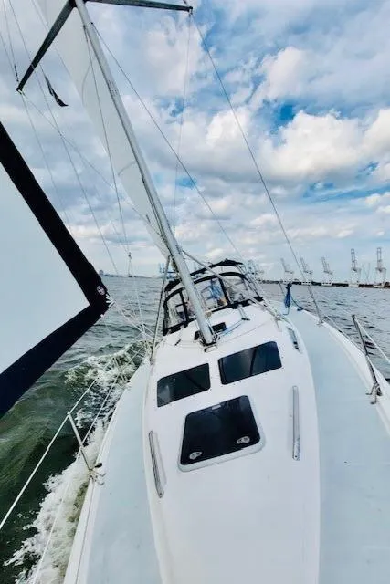 Slide: The Image of 2002 Hunter 356 sailboat navigating open waters. - 17
