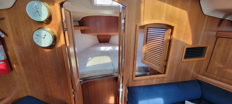 Slide: The Image of Interior of a 2002 Hunter 356 yacht with wooden finish. - 19