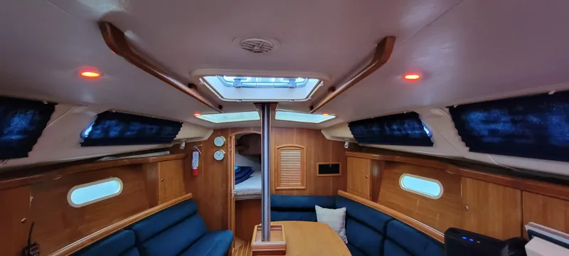 Slide: The Image of Interior of a 2002 Hunter 356 yacht with blue seating. - 23