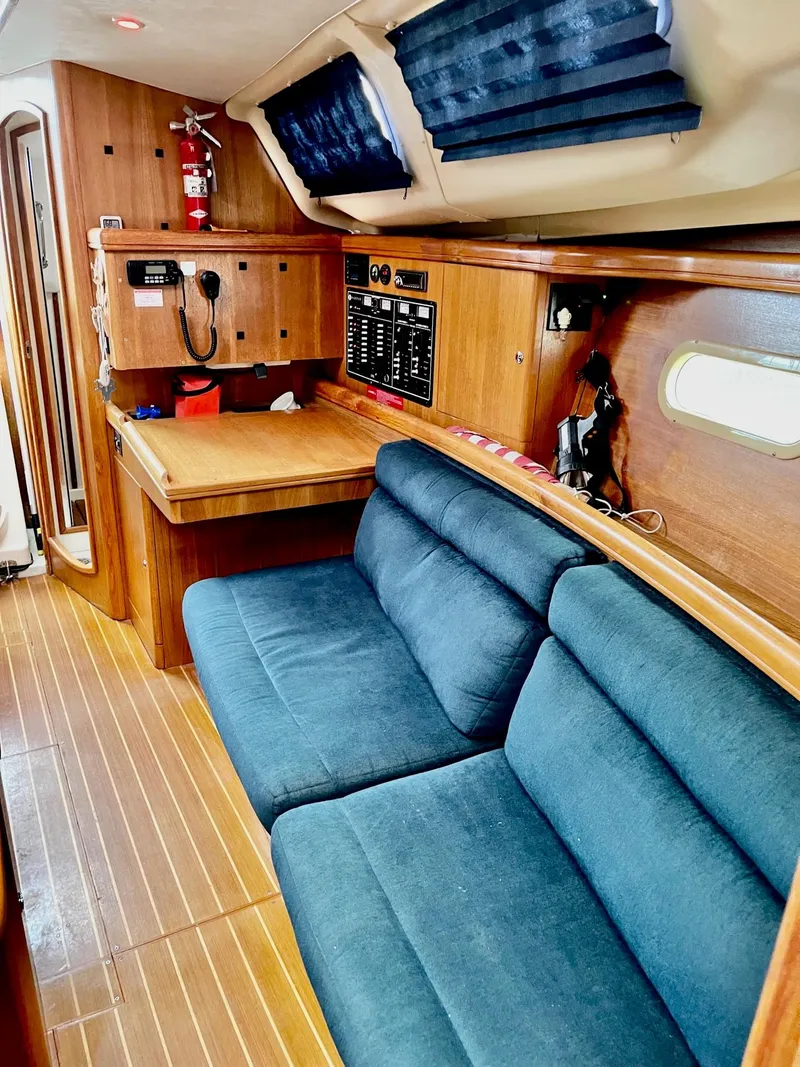 Slide: The Image of Interior of a 2002 Hunter 356 yacht with blue upholstery. - 24