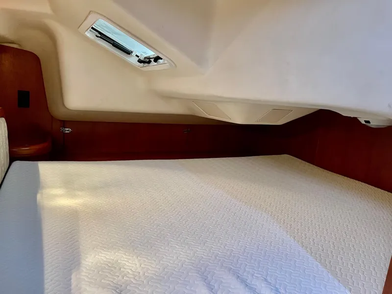 Slide: The Image of Interior of a 2002 Hunter 356 yacht featuring a cozy sleeping area. - 26