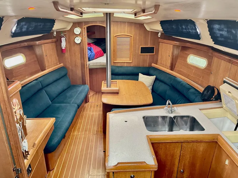 Slide: The Image of Interior of a 2002 Hunter 356 yacht with kitchen and seating area. - 28