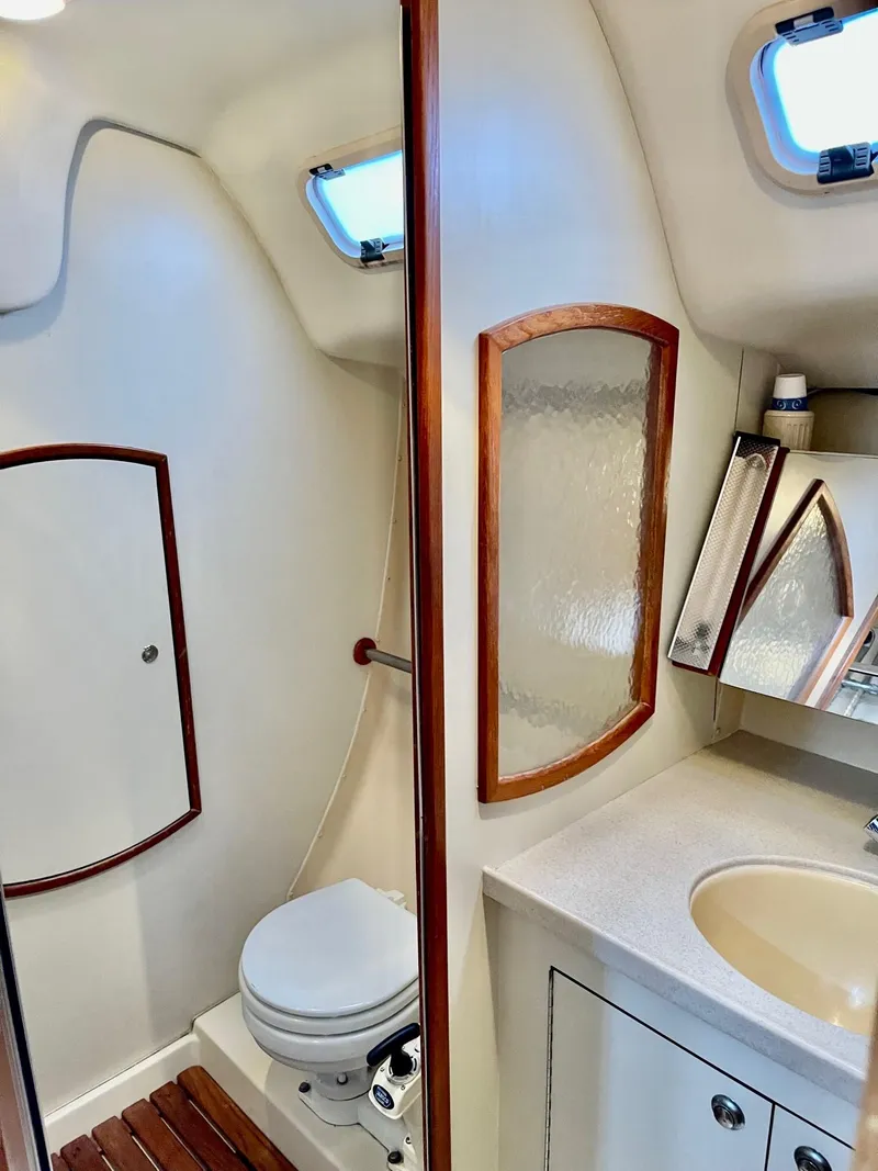 Slide: The Image of Interior of a 2002 Hunter 356 yacht, bathroom with toilet and sink. - 29