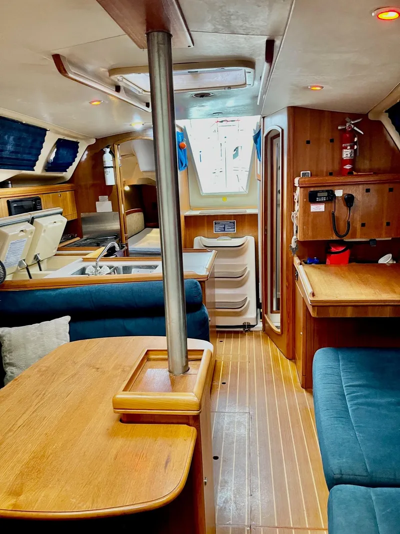Slide: The Image of Interior of a 2002 Hunter 356 sailboat with wooden furnishings. - 30