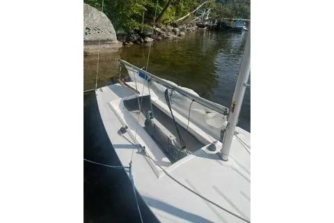 Slide: The Image of 2016 Flying Scot 19 sailboat docked by a scenic lakeside. - 3