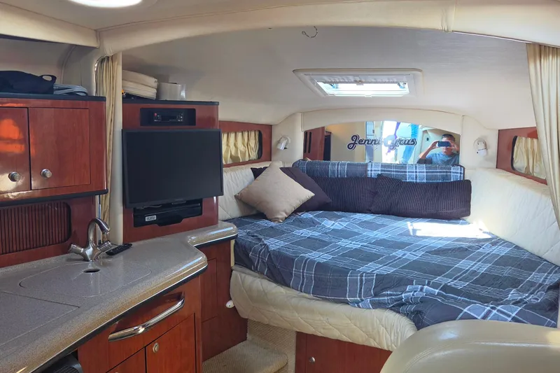 Slide: The Image of Luxurious 2006 Sea Ray 300 Sundancer cabin interior with cozy bed and modern amenities. - 11