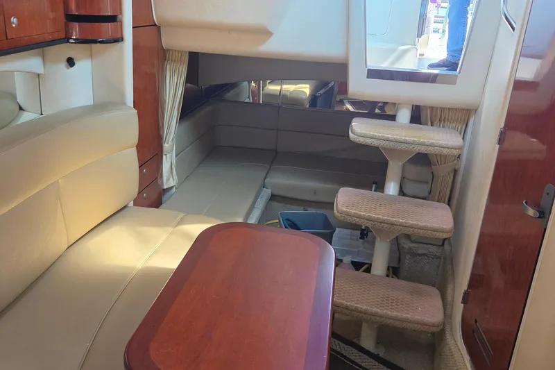 Slide: The Image of Interior of a 2006 Sea Ray 300 Sundancer boat with seating and stairs. - 14