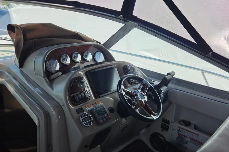 Slide: The Image of Helm of 2006 Sea Ray 300 Sundancer with steering wheel and instrument panel. - 5