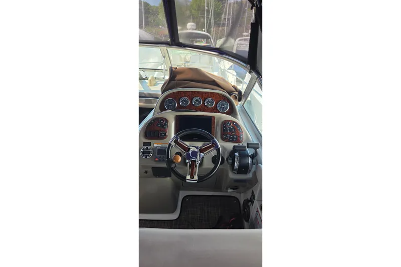 Slide: The Image of Helm of 2006 Sea Ray 300 Sundancer with gauges and steering wheel. - 7