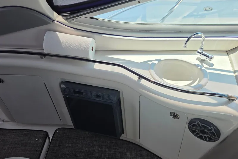 Slide: The Image of Interior of 2006 Sea Ray 300 Sundancer with sink, faucet, and paper towel holder. - 9