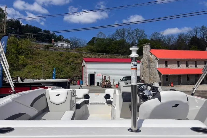 Slide: The Image of 2026 Starcraft SVX 191 OB boat interior at a dealership, with buildings and trees in the background. - 3