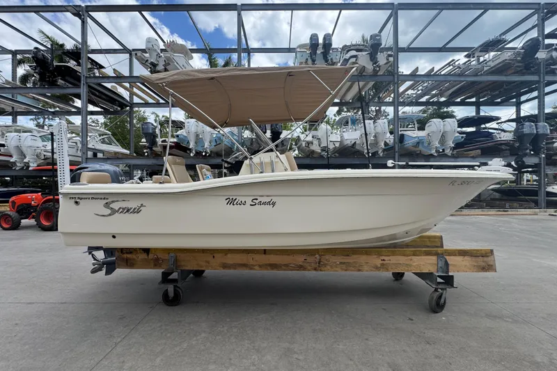 The Image of 2022 Scout 195 Sport Dorado boat on display in a marina storage area. - 0