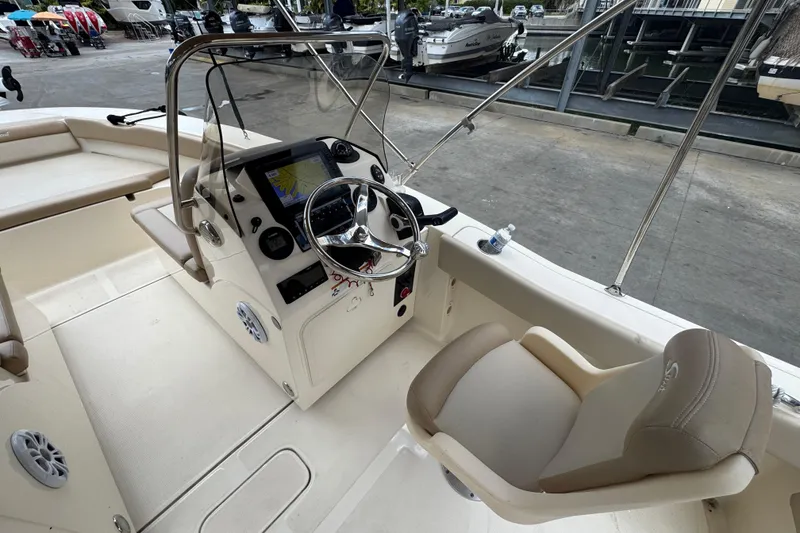 Slide: The Image of 2022 Scout 195 Sport Dorado boat interior with steering wheel and seating. - 11