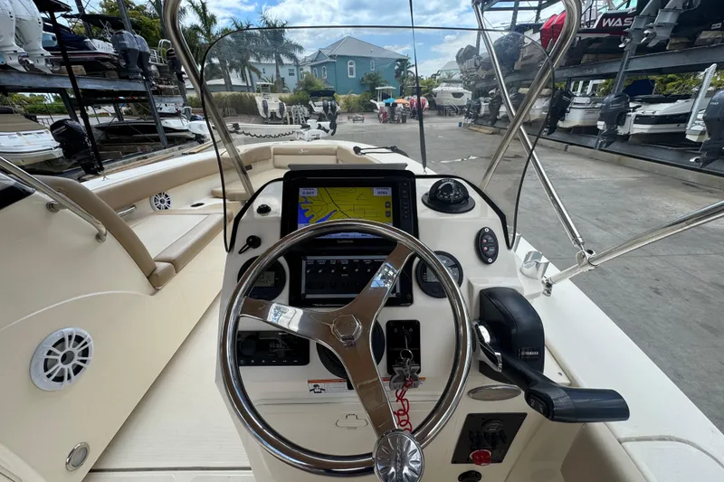 Slide: The Image of 2022 Scout 195 Sport Dorado boat dashboard with steering wheel and navigation system. - 12