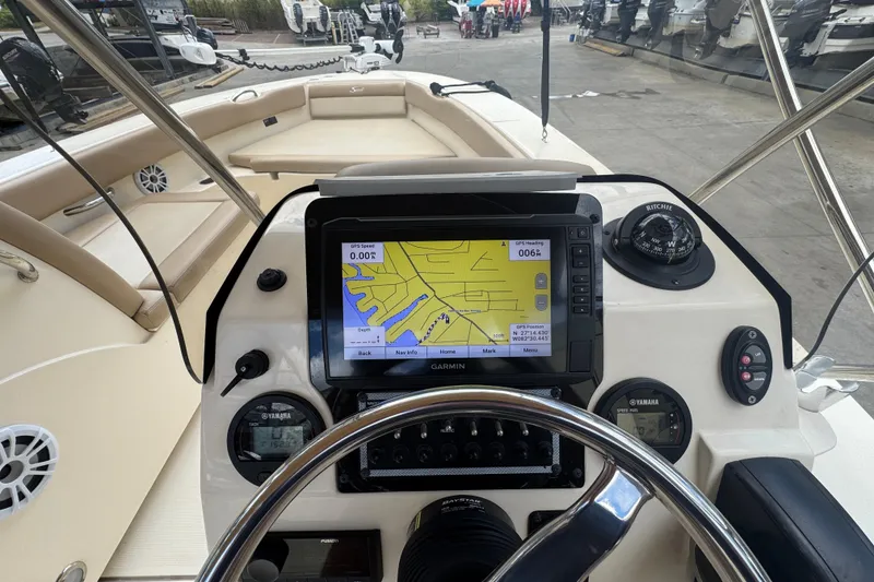 Slide: The Image of 2022 Scout 195 Sport Dorado boat dashboard with GPS navigation system and steering wheel. - 13