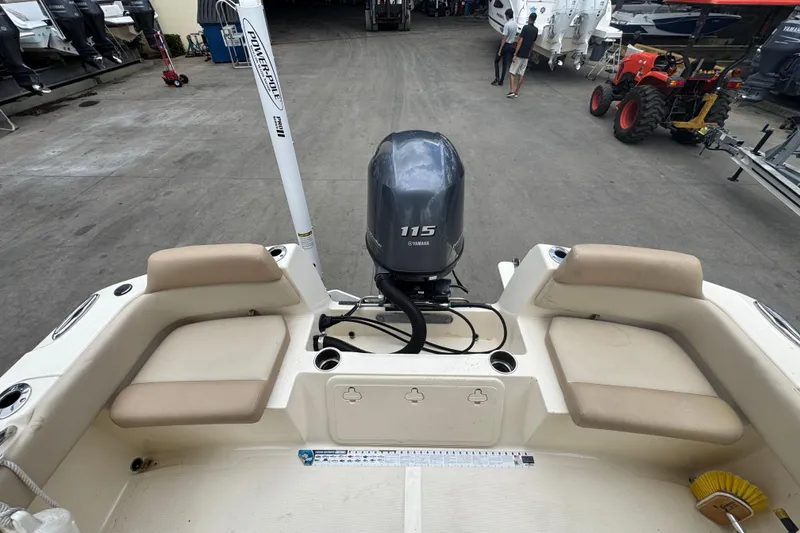 Slide: The Image of 2022 Scout 195 Sport Dorado boat with Yamaha 115 engine in a marina setting. - 15