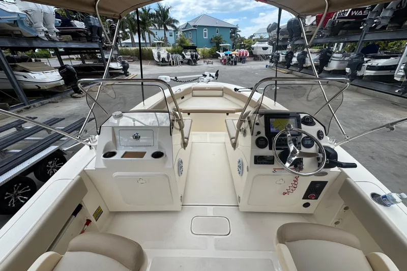 Slide: The Image of 2022 Scout 195 Sport Dorado boat interior with steering console and seating. - 16