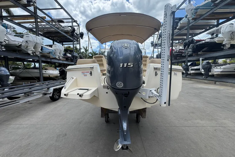 Slide: The Image of 2022 Scout 195 Sport Dorado boat with Yamaha 115 engine, docked in a marina. - 17