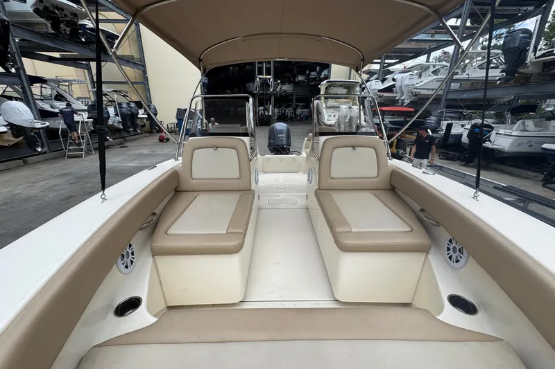 Slide: The Image of 2022 Scout 195 Sport Dorado boat interior with beige seating and canopy in storage facility. - 7