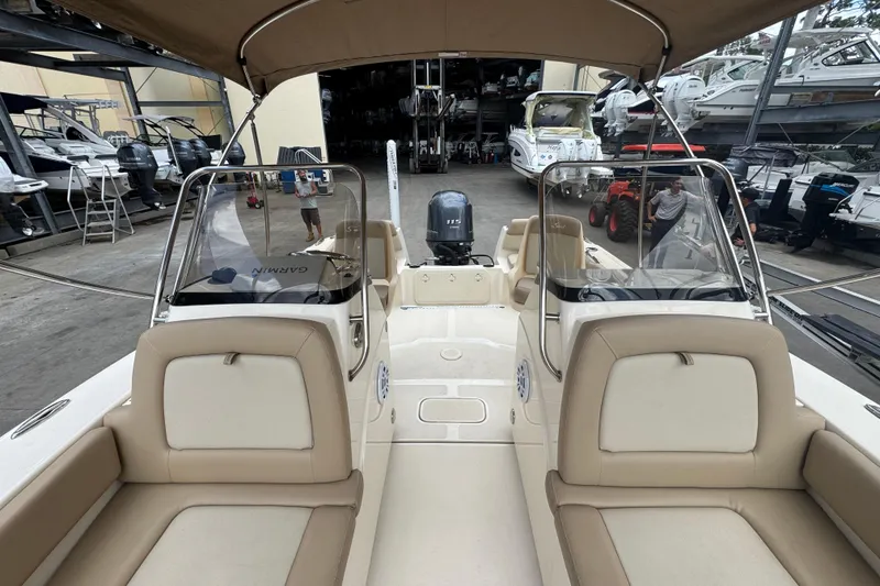 Slide: The Image of 2022 Scout 195 Sport Dorado boat interior with beige seating and dual consoles. - 9