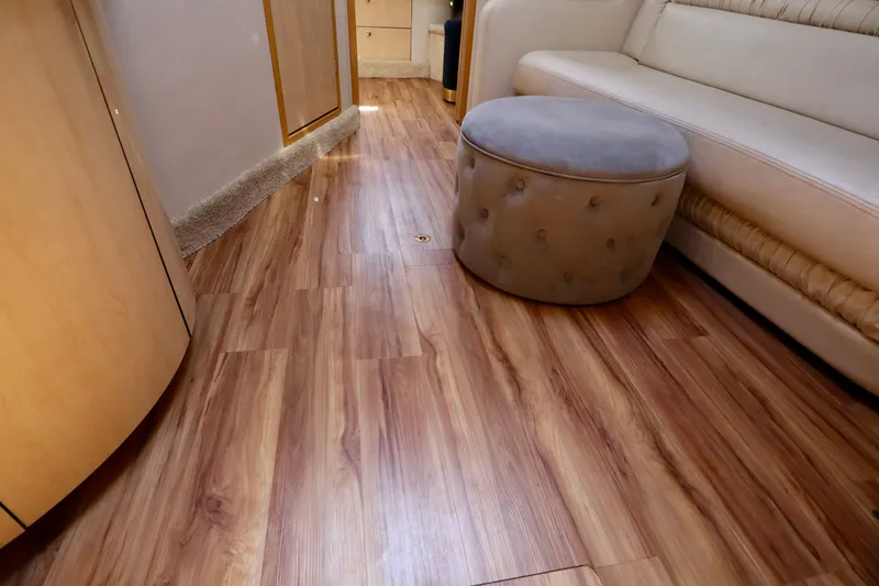 Slide: The Image of Sea Ray Sundancer 460 yacht interior, wood flooring and leather sofa. - 26