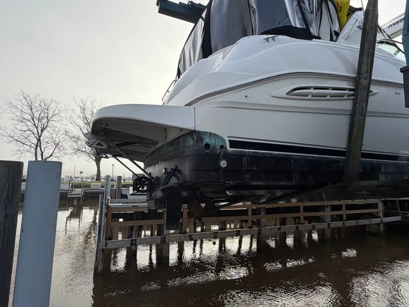 Slide: The Image of 1999 Sea Ray Sundancer 460 on a boat lift at the dock. - 48