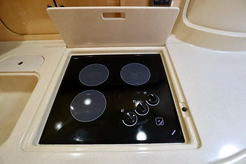 Slide: The Image of 1999 Sea Ray Sundancer 460 kitchen area with glass-ceramic cooktop. - 27