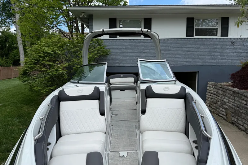 Slide: The Image of 2022 Crownline 280 SS boat with luxurious white seating and sleek design. - 13